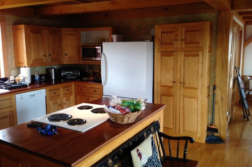 central vermont kitchen with wood cabinets and electric range before kitchen remodeling project by allied contractors