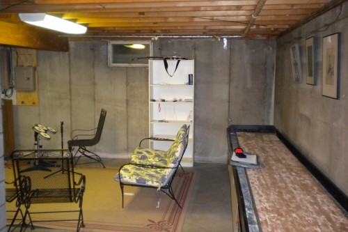 unfinished lightly furnished waitsfield basement space before remodeling project by allied contractors