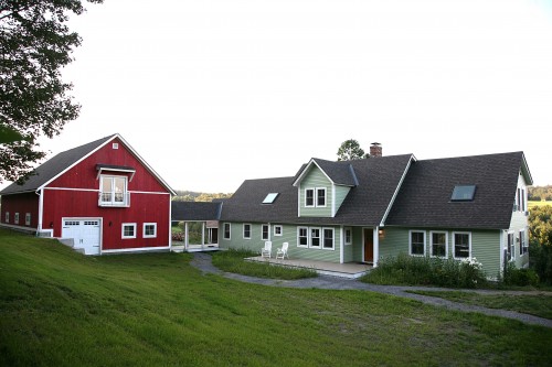 Red barn and green home in new build project in central vermont by allied builders