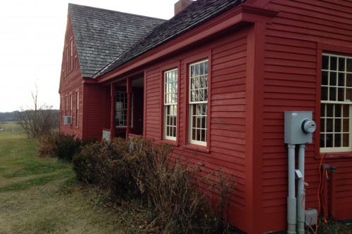 Exterior shot of red house before the start of a complete home remodeling project