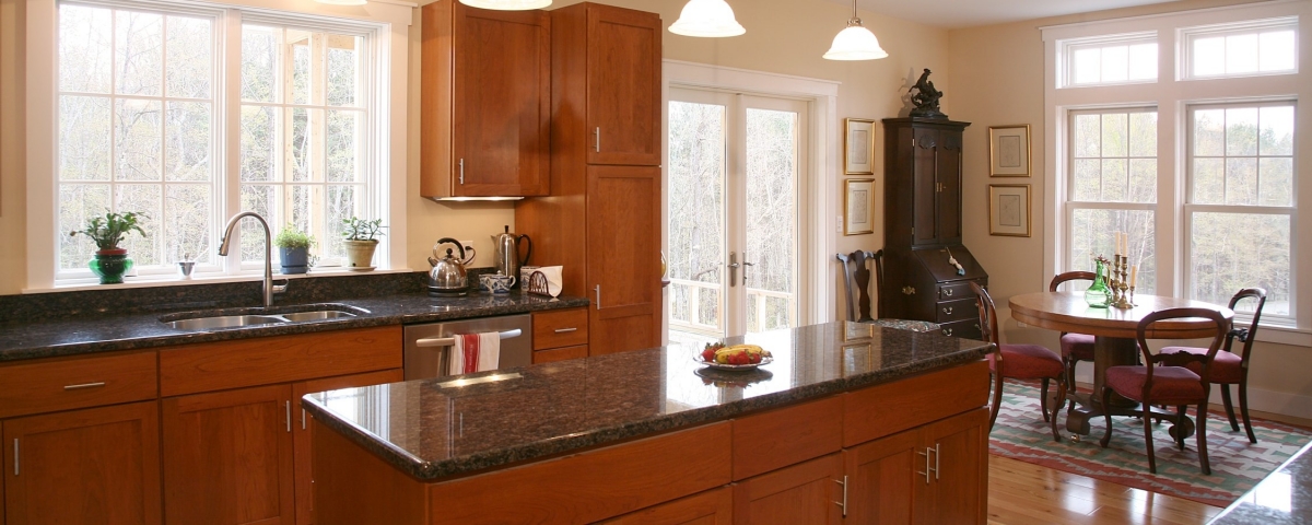 after completed kitchen renovation a large kitchen with black counters and large windows in central vermont