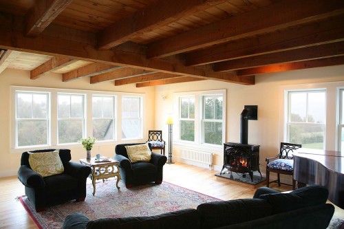 Furnished living space with green windows by allied home builders in central vermont