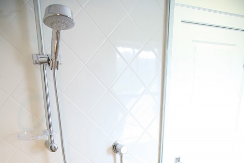 bright bathroom shower stall in new home build by allied builders