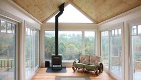 A light filled living area with windows on all sides in Central Vermont