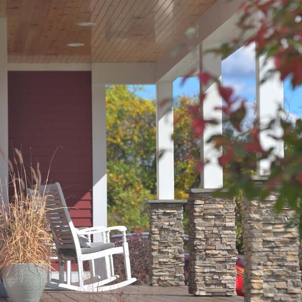 side view of a porch with rocking chairs