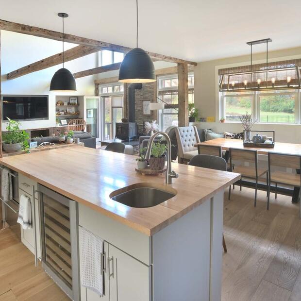 kitchen with wooden island overlooking dining space