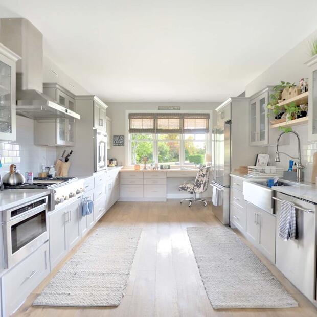 spacious kitchen with white cabinets and stainless steal appliances