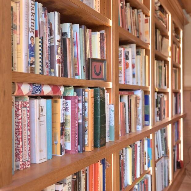 built-in wood bookshelves full of books