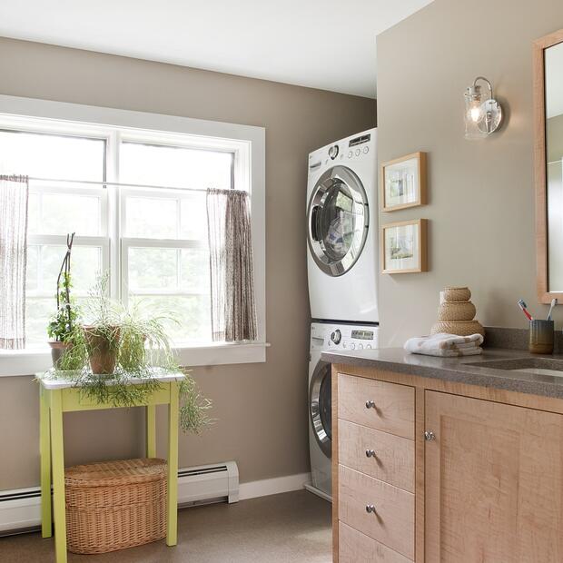 laundry and bathroom combo featuring natural light and cozy decor