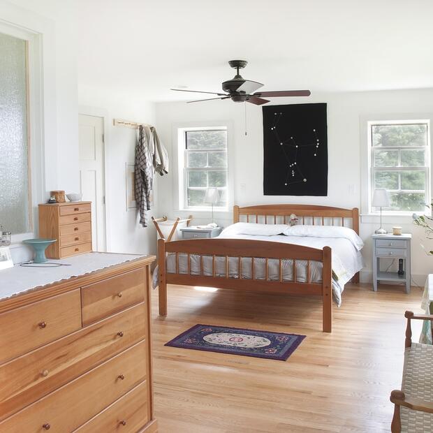 spacious primary bedroom with wood floors