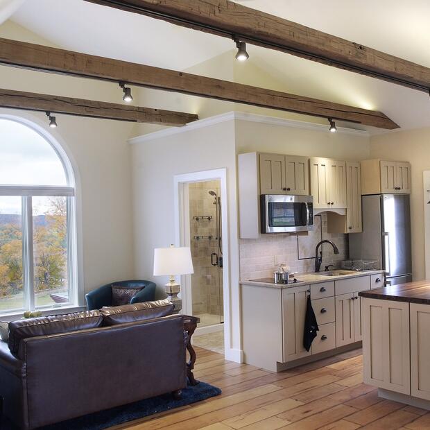 kitchen and living space with vaulted ceilings and large arched windows