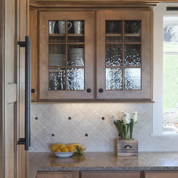 kitchen counter with wooden cabinets, a tiled backsplash, and fresh lemons