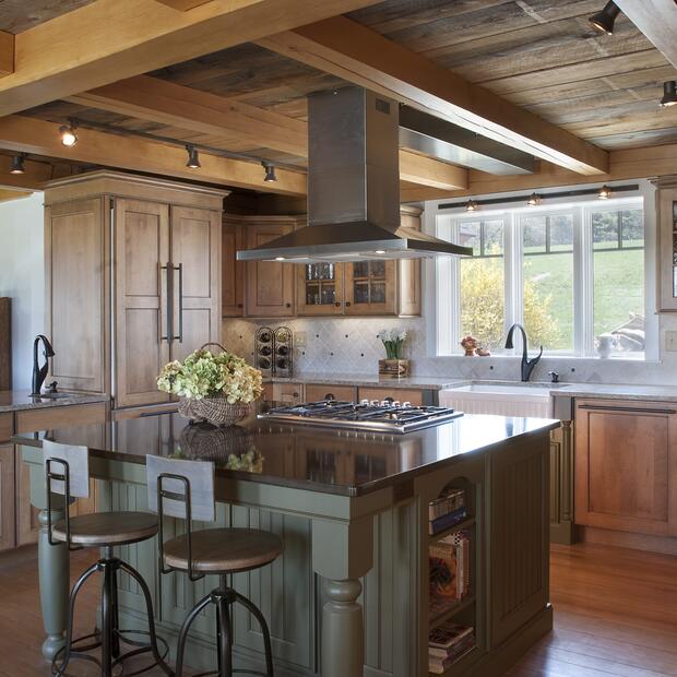 kitchen featuring a wood-paneled ceiling, modern appliances, and a central island