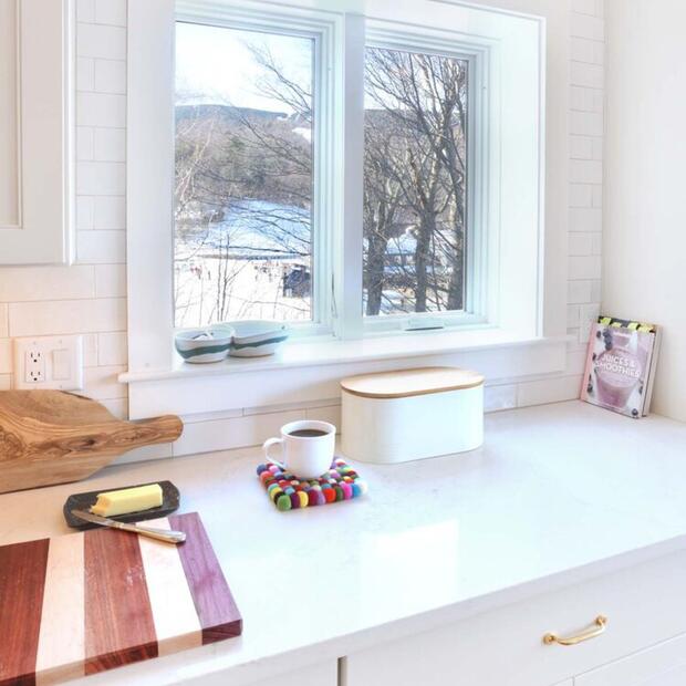 white kitchen countertop with window view of nature